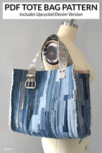 Load image into Gallery viewer, denim tote bag with belt handles hanging on the should of a bare mannequin with text above